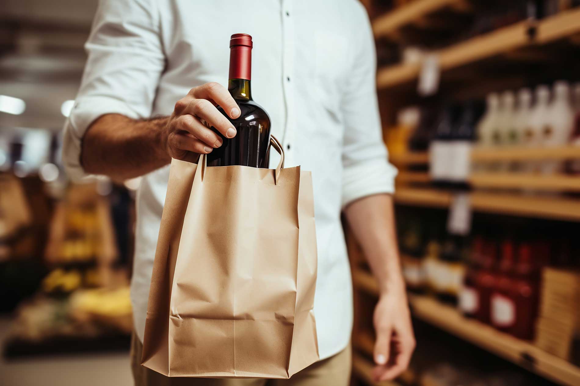 waiter bringing a bottle of wine to the table