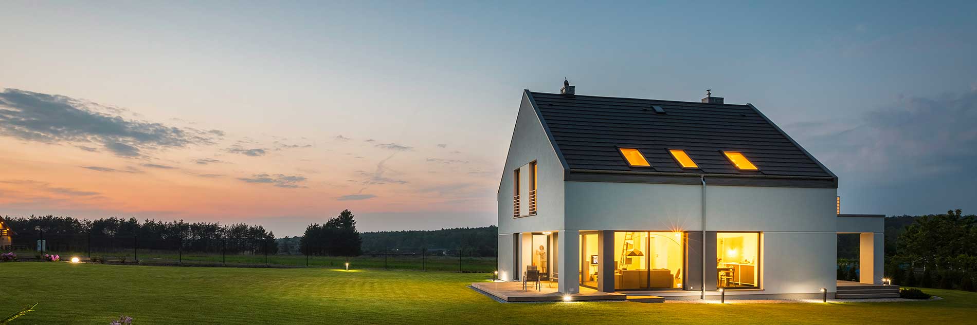 modern house in the background near a field